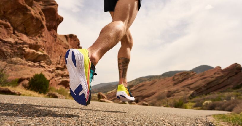 Un uomo corre su asfalto indossando scarpe da corsa